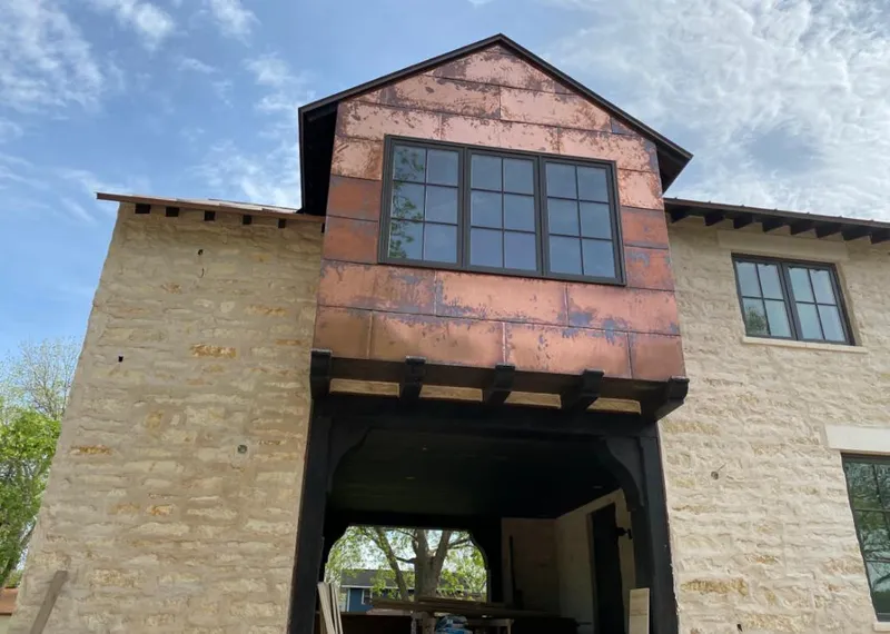 Copper metal panel facade on a stone building for Skylight Installation in Prineville